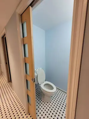a bathroom with a toilet in a room at Logement complet, proche métro, parking gratuit in Montréal