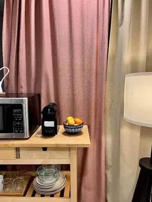 a bowl of fruit on a table next to a microwave at Logement complet, proche métro, parking gratuit in Montréal