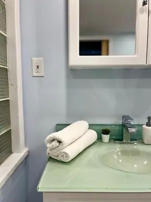 a bathroom with a sink and towels on a counter at Logement complet, proche métro, parking gratuit in Montréal