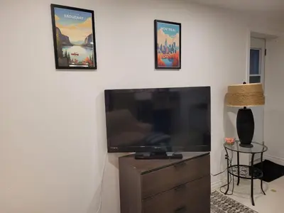 a living room with a large flat screen tv at Logement complet, proche métro, parking gratuit in Montréal