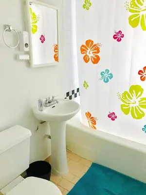 a bathroom with a sink and a shower curtain at Stylish Montreal Apartment: Comfortable Stay in the Golden Square Mile in Montréal