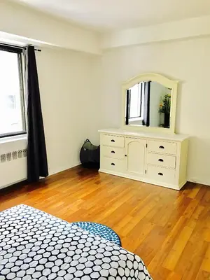 a bedroom with a dresser and a mirror in it at Stylish Montreal Apartment: Comfortable Stay in the Golden Square Mile in Montréal