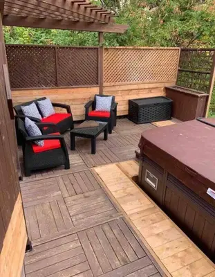 a patio with chairs and a table and a pergola at Chalet BIA - Le Petit Chaleureux in Ham Nord