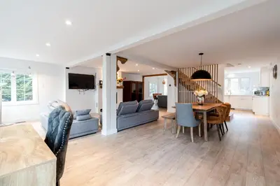 a living room and dining room with a table and chairs at lacbrome Chalet lake+Terrasse+BBQ+Hot-tub in Lac-Brome
