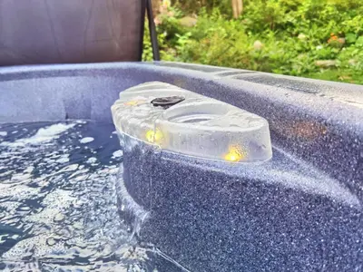 a hot tub filled with water with aperature at lacbrome Chalet lake+Terrasse+BBQ+Hot-tub in Lac-Brome