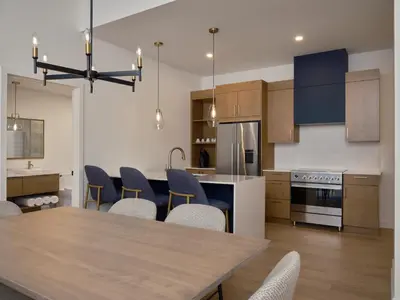 a kitchen and dining room with a table and chairs at Hôtel Expérience - Quartier Des Marinas in Magog-Orford