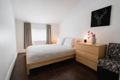 a bedroom with a bed and a dresser and a window at Bed and Breakfast du Village BBV in Montréal