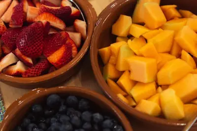 three plastic bowls filled with fruit on a table at Bed and Breakfast du Village BBV in Montréal