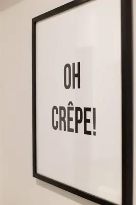 a picture frame on a wall with the words out agee at 6768 - 102 Cozy and Fresh Mini Studio with kitchen by Denstays in Montréal