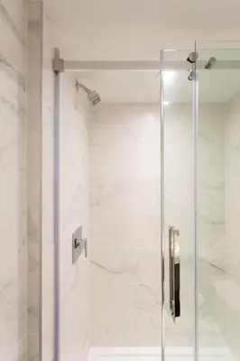 a shower with a glass door in a bathroom at 6768 - 102 Cozy and Fresh Mini Studio with kitchen by Denstays in Montréal