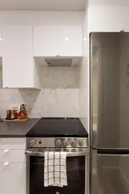 a kitchen with a stainless steel stove and white cabinets at 6768 - 102 Cozy and Fresh Mini Studio with kitchen by Denstays in Montréal