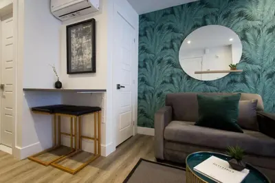 a living room with a couch and a mirror at 6768 - 202 Amazing mini studio with full kitchen by Denstays in Montréal