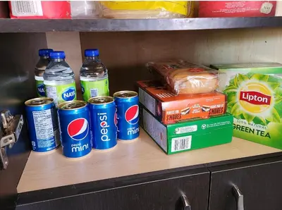 a shelf with pepsi cans and other items on it at Maison chaleureuse, énergétique et florale in Sherbrooke