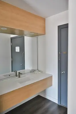 a bathroom with a sink and a mirror at Motel Mascouche in Mascouche