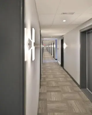 a hallway of an office building with a long corridor at Motel Mascouche in Mascouche