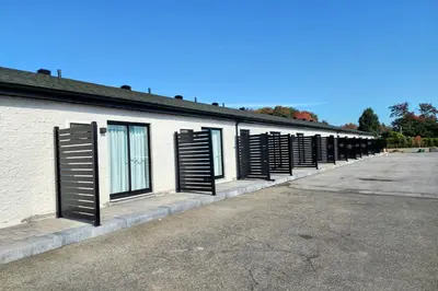 a row of shuttered windows on a building at Motel Mascouche in Mascouche