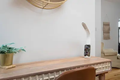 a living room with a wooden table and a chair at Downtown Luxe: Metro, King Bed, Parking, Sleeps 6 in Montréal
