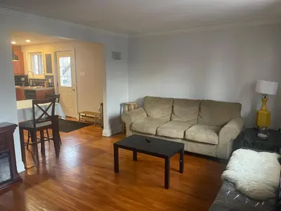 a living room with a couch and a table at Appartement près du Métro in Laval