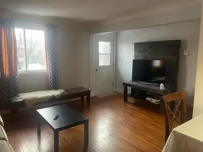 a living room with a couch and a television at Appartement près du Métro in Laval