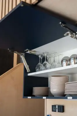 a shelf with wine glasses and plates on it at Cabin Zoobox 47 in Eastman