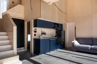 a kitchen with a sink and a couch in a room at Cabin Zoobox 47 in Eastman