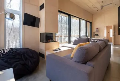 a living room with a blue couch and a tv at Cottage Zoobox-style 51 in Eastman
