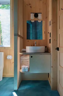 a bathroom with a sink and a mirror at Cabin Zoobox 57 in Eastman