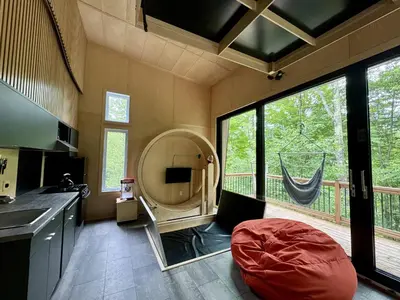 a kitchen with a large mirror in the middle of a room at Cabin Zoobox 63 in Eastman