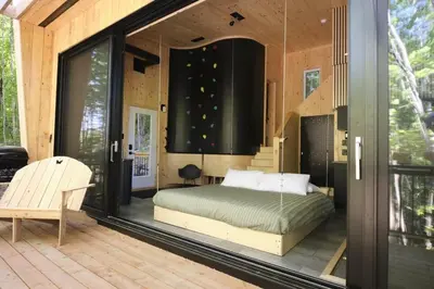 a bedroom with a bed on a screened in porch at Cabin Zoobox 69 in Eastman