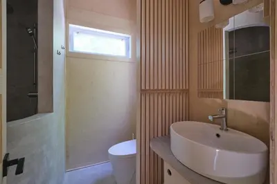 a bathroom with a sink and a toilet and a window at Cabin Zoobox 73 in Eastman