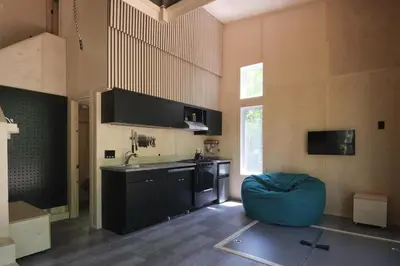 a kitchen with a blue ottoman in a room at Cabin Zoobox 73 in Eastman