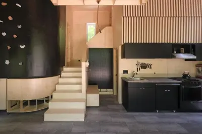 a kitchen with a staircase leading up to a stair case at Cabin Zoobox 73 in Eastman