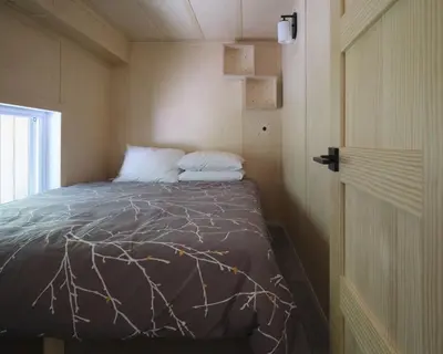 a bedroom with a bed in a small room at Cabin Zoobox 73 in Eastman