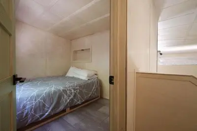a small bedroom with a bed in a room at Cabin Zoobox 73 in Eastman