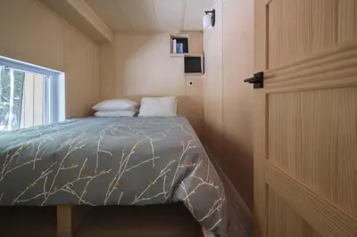 a bedroom with a bed in a small room at Cabin Zoobox 74 in Eastman