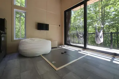 a room with a white bean bag chair in front of a window at Cabin Zoobox 74 in Eastman