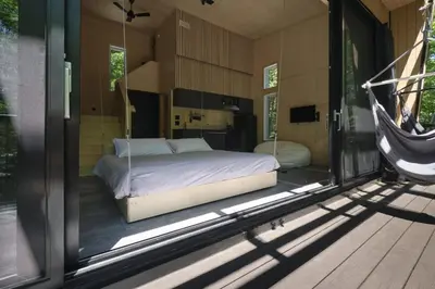 a bedroom with a bed inside of a house at Cabin Zoobox 74 in Eastman
