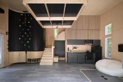 a large room with a kitchen and a staircase at Cabin Zoobox 74 in Eastman