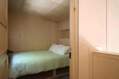 a small bedroom with a bed in a room at Cabin Zoobox 75 in Eastman