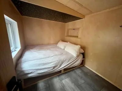 a small bedroom with a bed in a small room at Cabin Zoobox 76 in Eastman