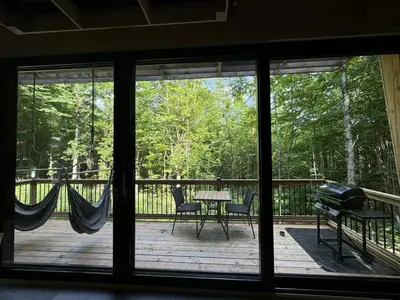 a screened in porch with a table and chairs at Cabin Zoobox 76 in Eastman