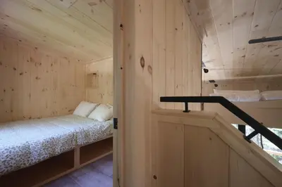 a room with a bed in a wooden cabin at Cabin Zoobox 89 in Eastman
