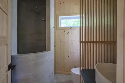 a bathroom with a shower and a tub and a sink at Cabin Zoobox 89 in Eastman