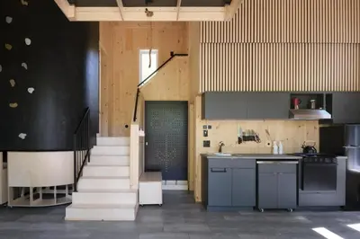a kitchen with a staircase leading up to a stair case at Cabin Zoobox 89 in Eastman