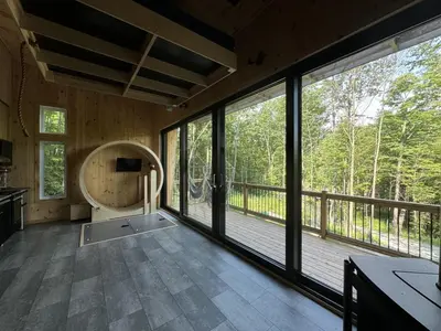 a large room with large windows and a balcony at Cabin Zoobox 79 in Eastman