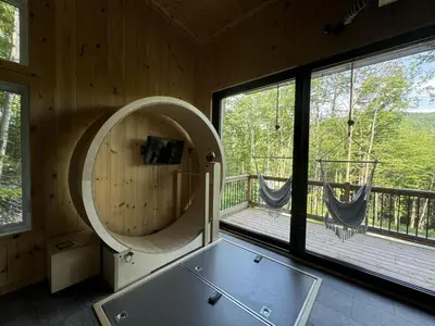 a room with a pool table and a large window at Cabin Zoobox 79 in Eastman