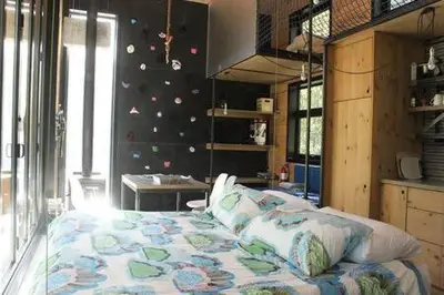 a bedroom with a large bed and a wall with stickers at Cabin Zoobox 54 in Eastman