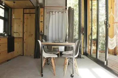 a dining room with a table and some chairs at Cabin Zoobox 54 in Eastman
