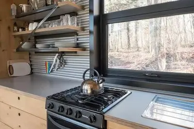 a tea kettle sitting on top of a stove in a kitchen at Cabin Zoobox 54 in Eastman
