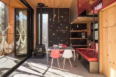 a room with a table and chairs in a house at Cabin Zoobox 56 in Eastman